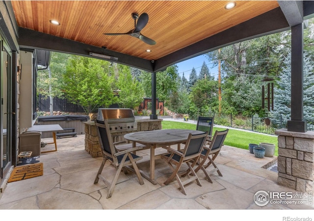 view of patio / terrace featuring ceiling fan and a hot tub