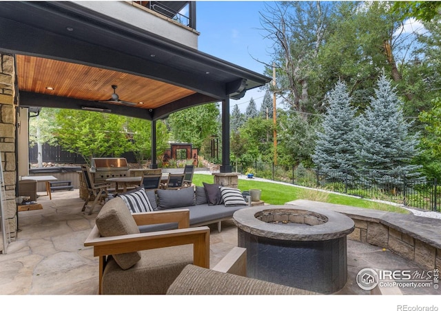 view of patio / terrace featuring ceiling fan, grilling area, and an outdoor living space with a fire pit