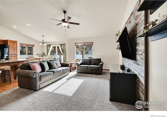 carpeted living room featuring ceiling fan and lofted ceiling