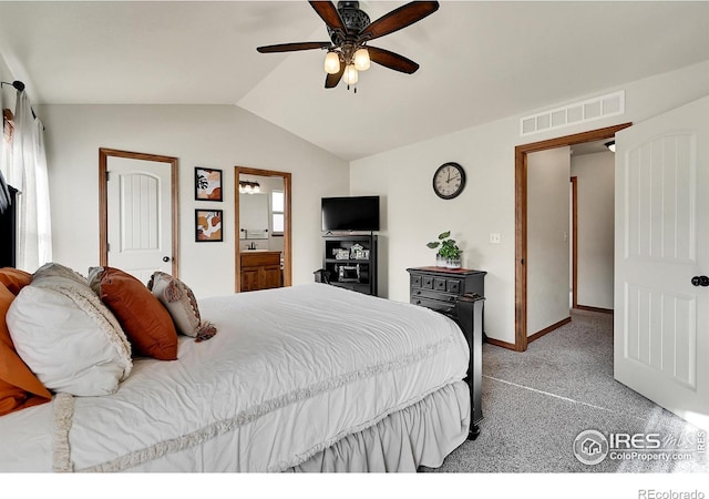 carpeted bedroom featuring ceiling fan, ensuite bathroom, and vaulted ceiling