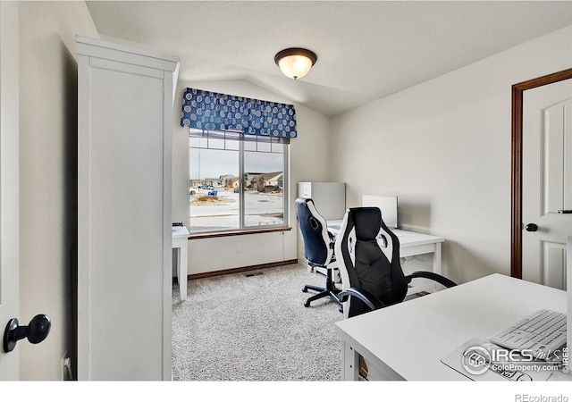 office space featuring carpet floors and vaulted ceiling