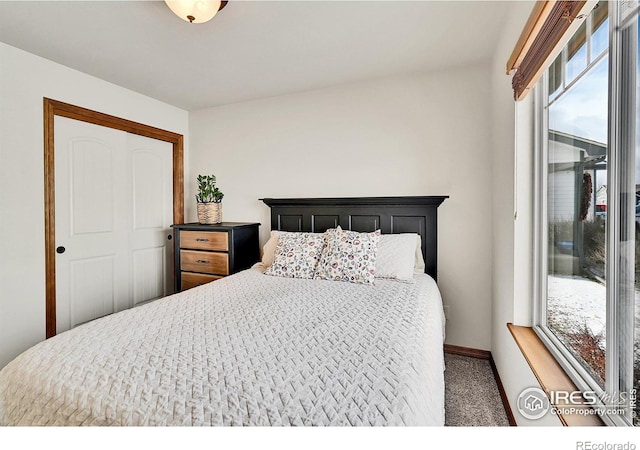 bedroom featuring a closet and dark carpet