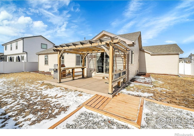 snow covered rear of property featuring a patio and a pergola