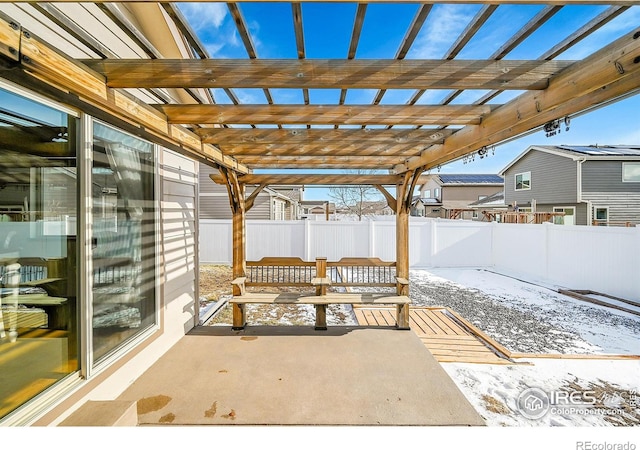 snow covered patio with a pergola