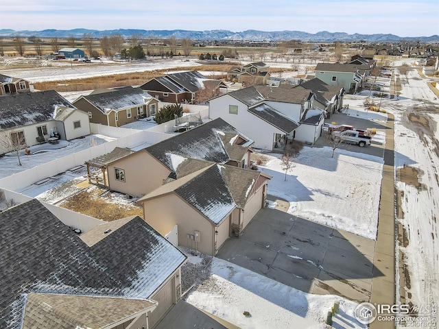 snowy aerial view featuring a mountain view