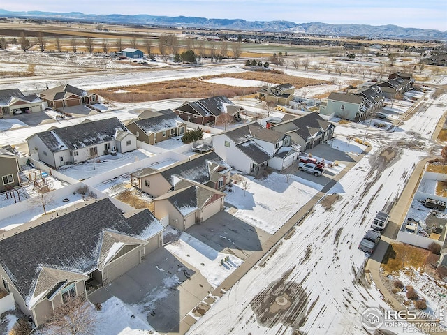 snowy aerial view featuring a mountain view