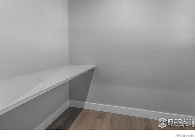 spacious closet with dark hardwood / wood-style flooring