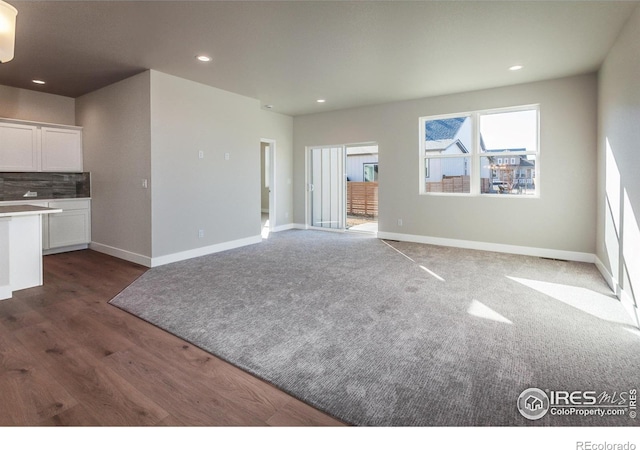 unfurnished living room featuring dark hardwood / wood-style floors
