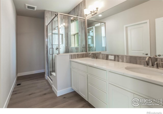 bathroom with vanity, hardwood / wood-style floors, and walk in shower