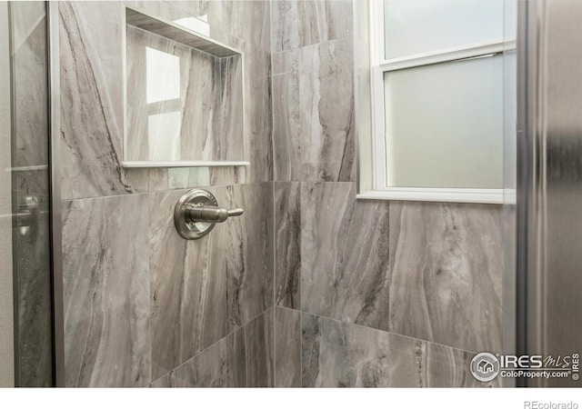 bathroom with tiled shower