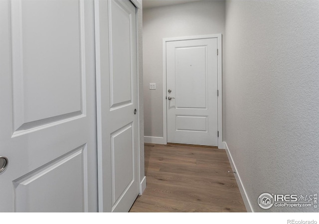 corridor with wood-type flooring