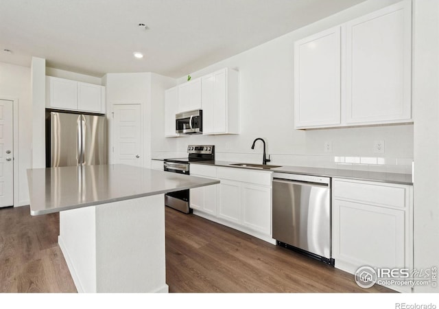 kitchen with sink, white cabinets, a center island, and appliances with stainless steel finishes