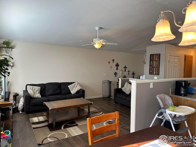 living room featuring ceiling fan, a textured ceiling, lofted ceiling, and dark hardwood / wood-style flooring