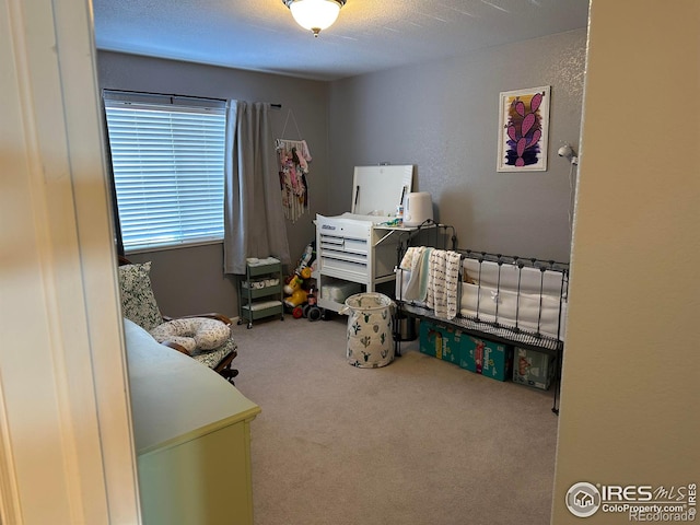 bedroom with carpet floors and a textured ceiling