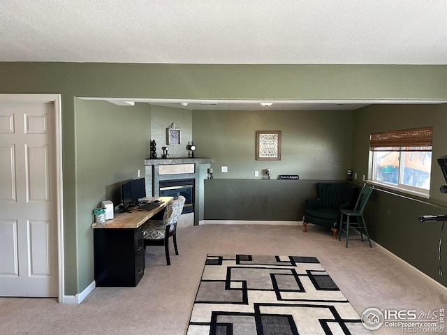 office with a textured ceiling and light carpet