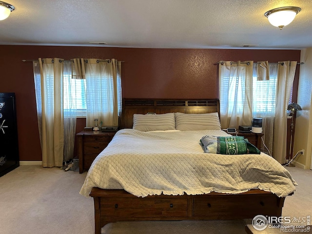 carpeted bedroom featuring a textured ceiling