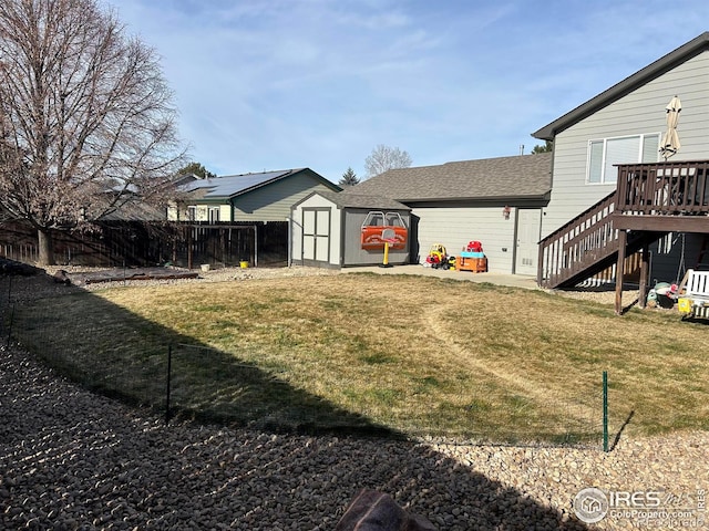 view of yard featuring a storage shed and a deck