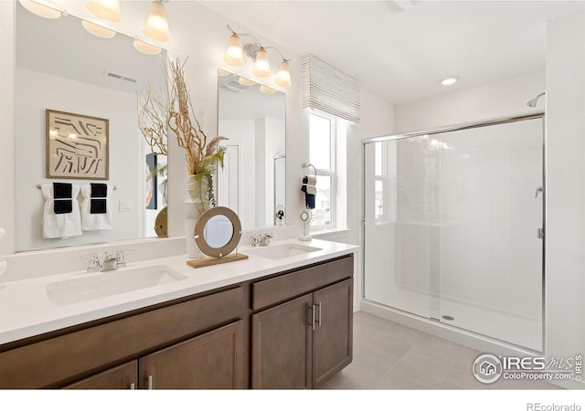 bathroom featuring walk in shower and vanity