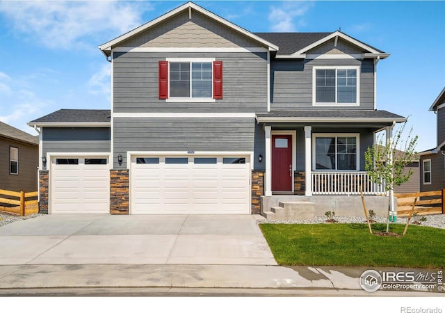 view of front of home featuring a garage and a porch