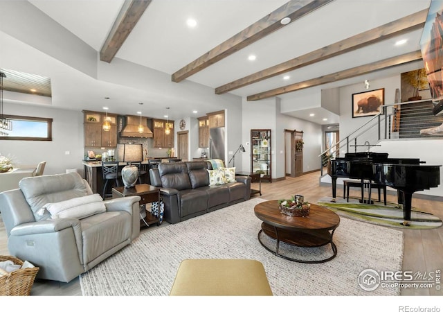 living room with light wood-type flooring and beamed ceiling