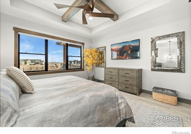 bedroom with ceiling fan, beamed ceiling, and light hardwood / wood-style flooring