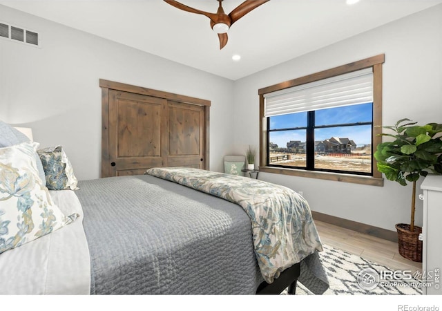 bedroom featuring ceiling fan and light hardwood / wood-style floors