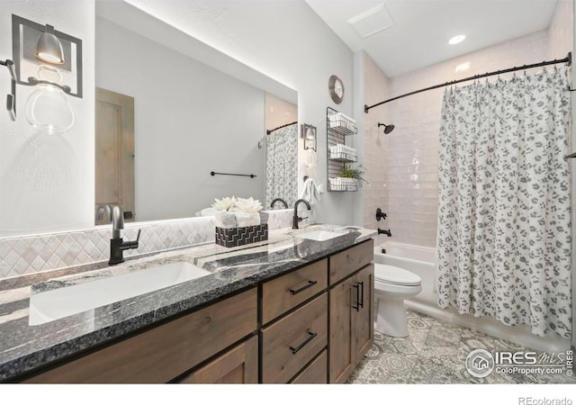 full bathroom featuring backsplash, toilet, vanity, and shower / tub combo