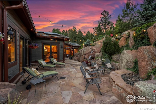 view of patio terrace at dusk