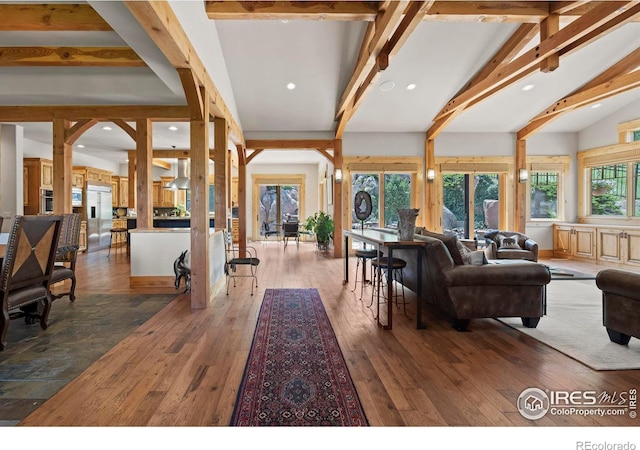 living room featuring hardwood / wood-style floors and vaulted ceiling with beams