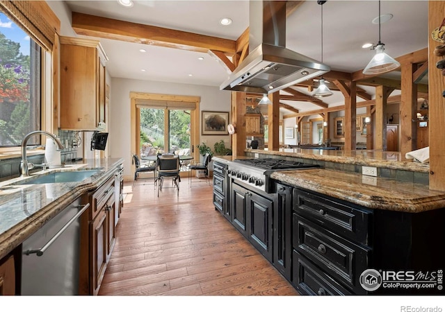 kitchen featuring pendant lighting, sink, island exhaust hood, beamed ceiling, and stainless steel appliances