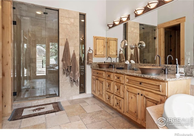 bathroom featuring vanity and separate shower and tub