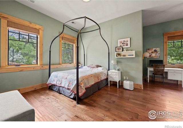 bedroom with hardwood / wood-style floors