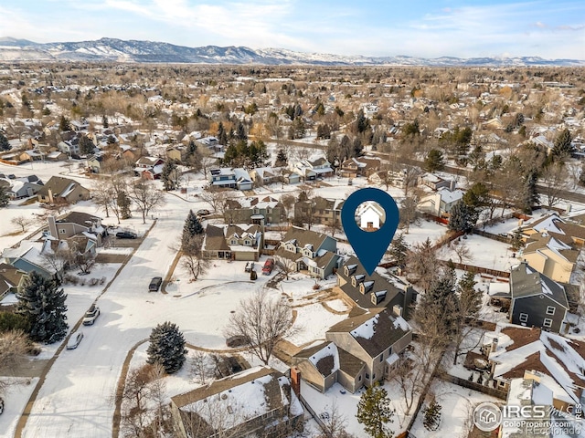 snowy aerial view with a mountain view