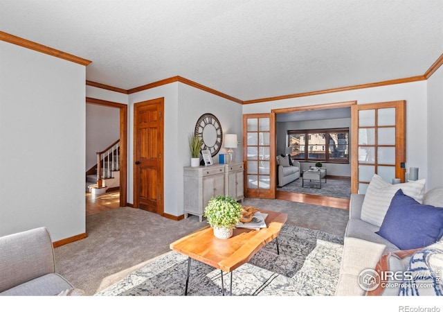 carpeted living room featuring ornamental molding, a textured ceiling, and french doors