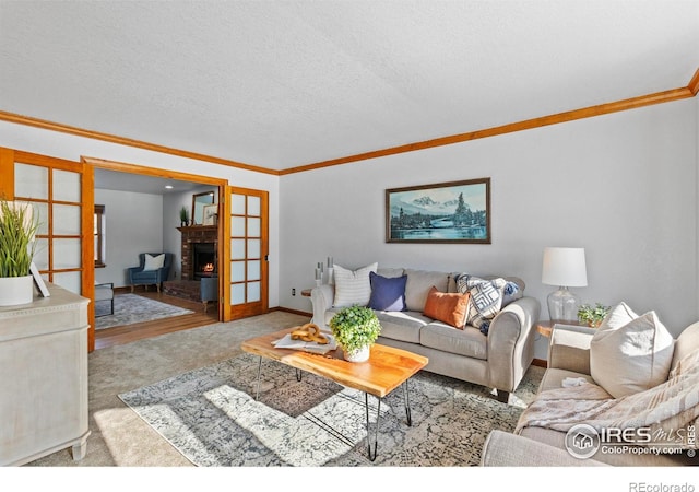 carpeted living room with ornamental molding, a textured ceiling, and a fireplace