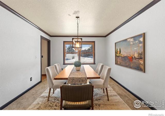 carpeted dining space featuring ornamental molding and a textured ceiling