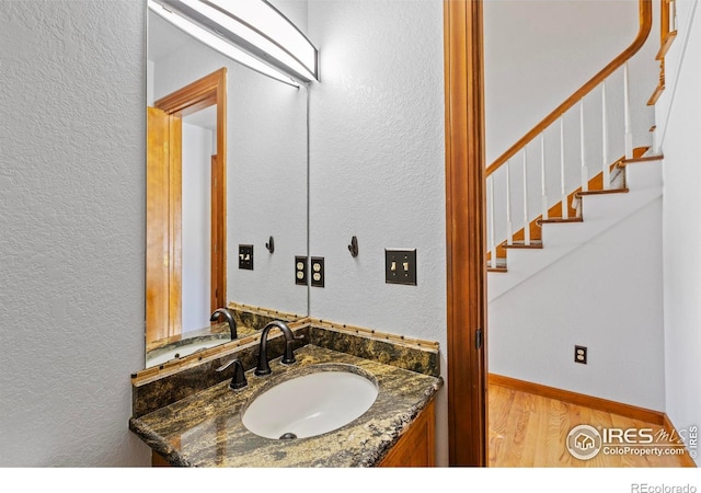 bathroom with vanity and hardwood / wood-style flooring