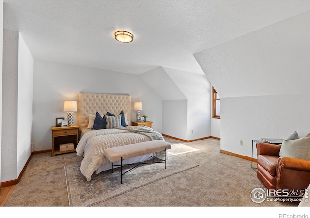 bedroom featuring lofted ceiling, carpet flooring, and a textured ceiling