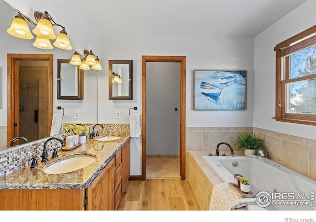 bathroom featuring vanity, shower with separate bathtub, and hardwood / wood-style floors