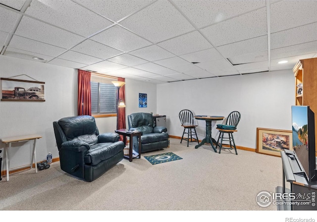 living room with a paneled ceiling and carpet flooring