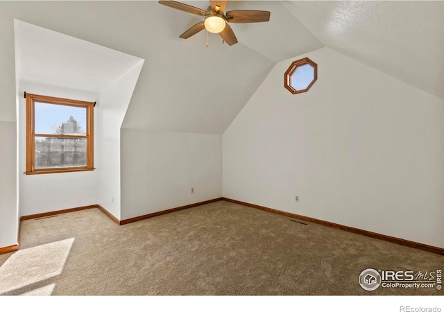 additional living space with light carpet and lofted ceiling