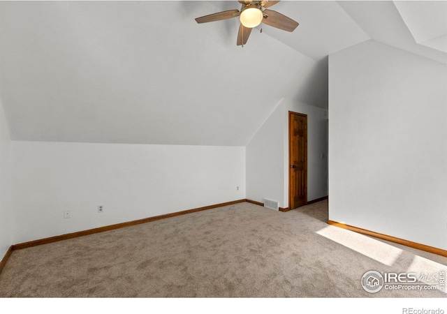 bonus room featuring lofted ceiling, light carpet, and ceiling fan