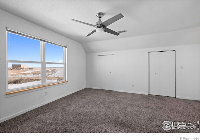 interior space with ceiling fan, carpet, and lofted ceiling