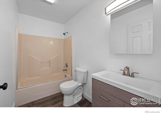 full bathroom featuring hardwood / wood-style floors,  shower combination, toilet, and vanity