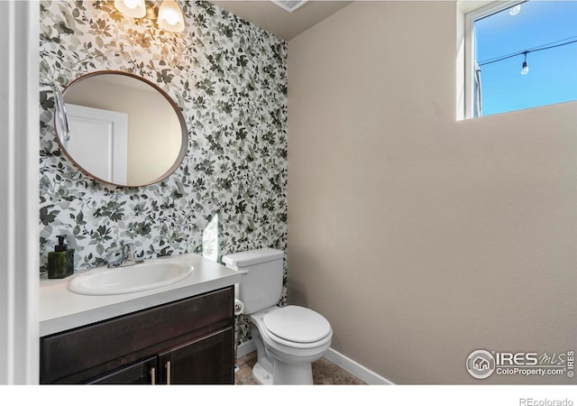 bathroom featuring vanity and toilet