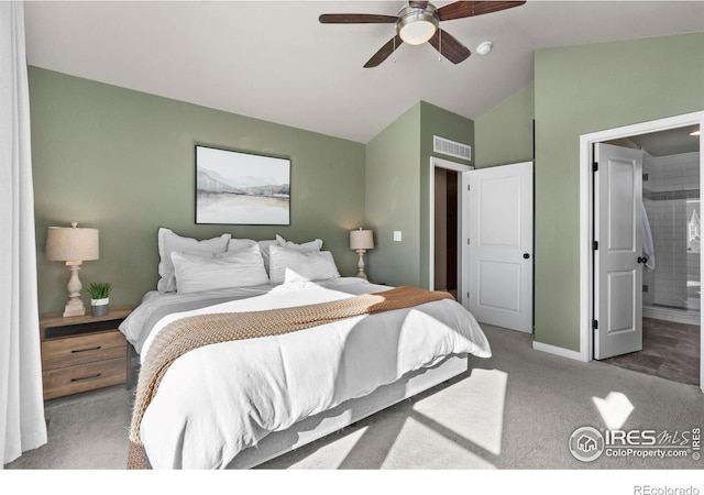 bedroom with lofted ceiling, carpet flooring, ceiling fan, and ensuite bathroom