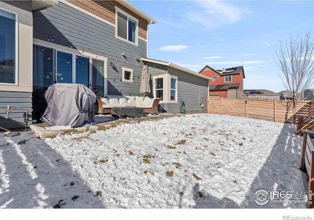 yard layered in snow with an outdoor living space