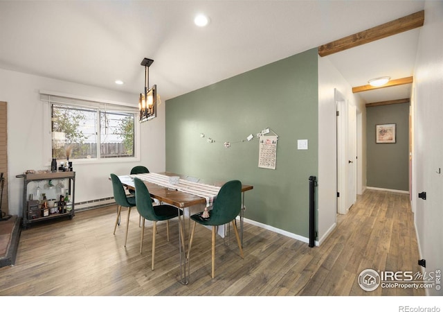 dining room with beam ceiling, hardwood / wood-style floors, and baseboard heating