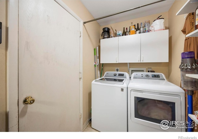 laundry area featuring cabinets and independent washer and dryer