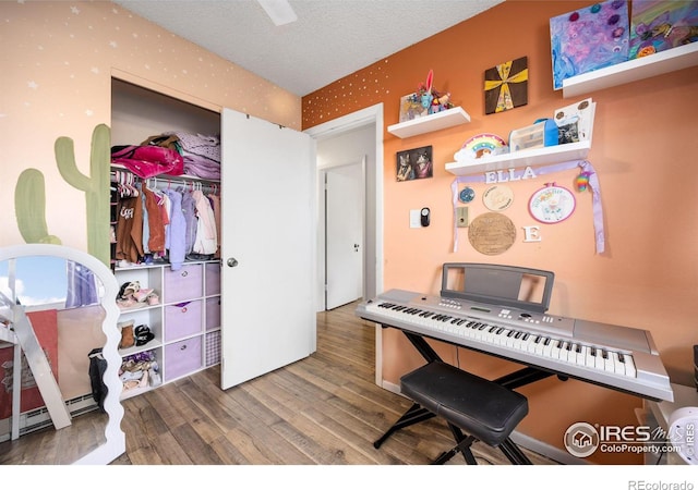 misc room featuring a textured ceiling and hardwood / wood-style floors